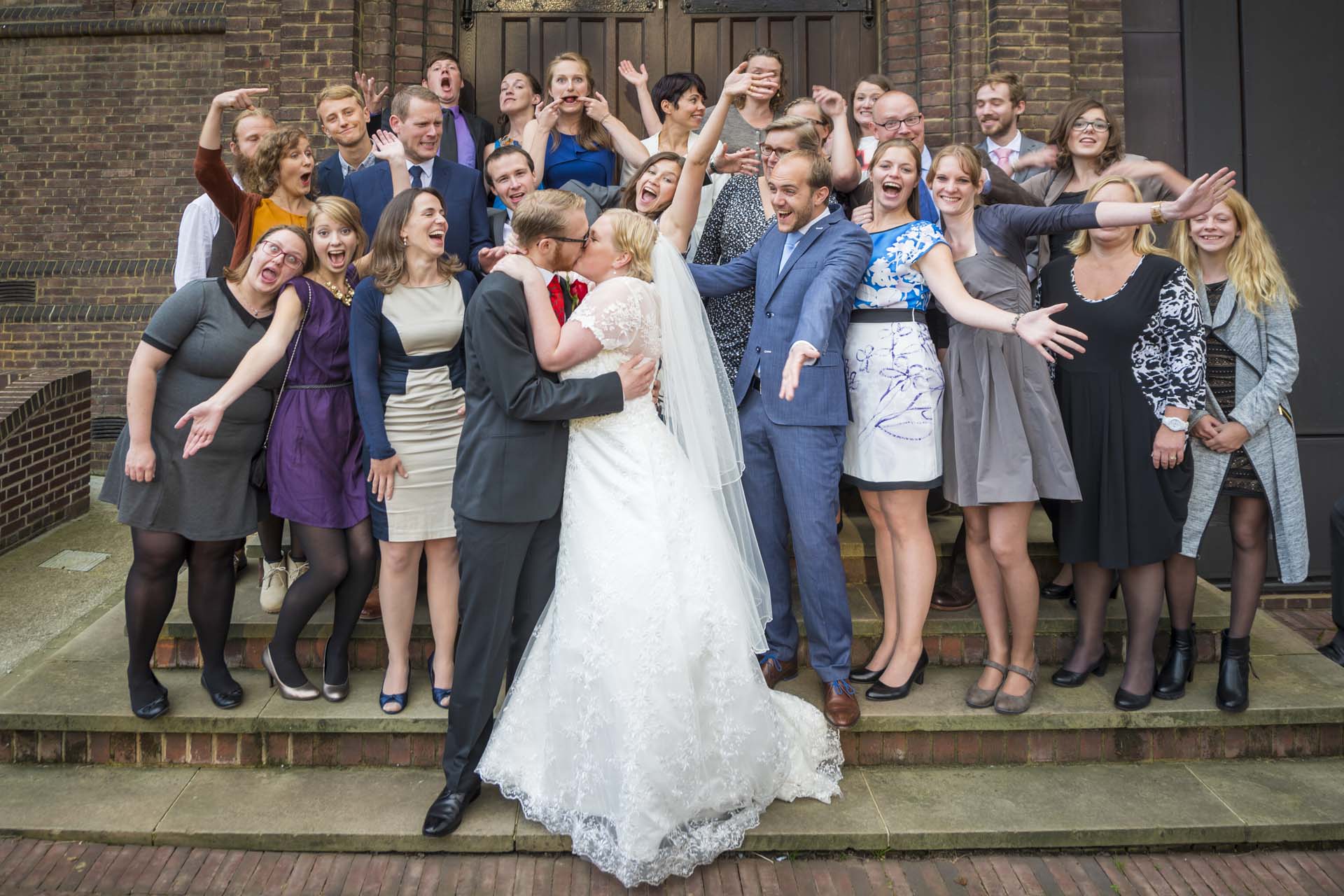 kissing couple with friends Camberwell wedding photographer article on extreme wide angle lenses
